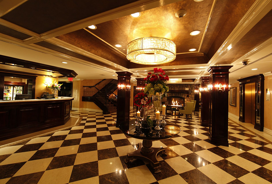 Candlelit hotel lobby with checkered floors.